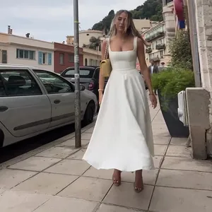 Elegant white sleeveless midi dress with a square neckline and a flowy flared skirt