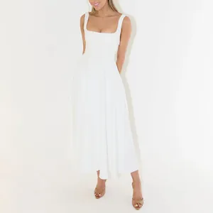 Full length view of a white square neck midi dress showing the fit and flared skirt.