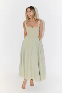 Elegant sage green square neck midi dress with a flared skirt and corset-style bodice.