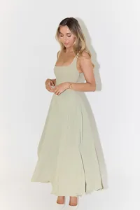 Elegant sleeveless sage green midi dress with square neckline shown on a studio model