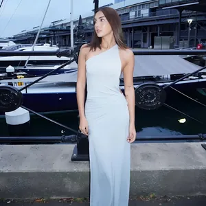 Full-length shot of an elegant light blue one-shoulder backless maxi evening dress.