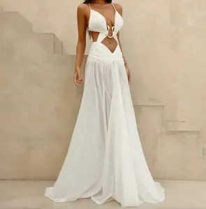 Elegant white cutout maxi dress with gold buckle detail for summer vacation style.