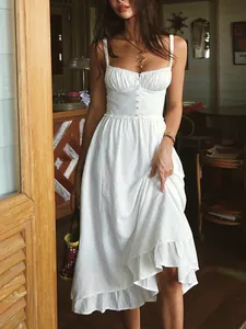 Elegant French style white camisole maxi dress with ruffled hem and button detail.