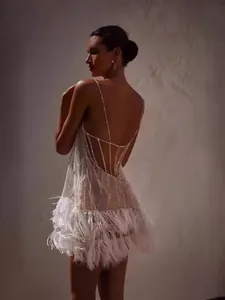 Elegantes rückenfreies weißes Pailletten-Minikleid für Partys mit Federquasten-Details