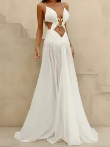 Elegant white cutout maxi dress for beach vacations with gold buckle detail