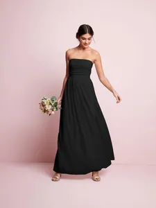 Full-length elegant black strapless pleated maxi dress worn by a model in a studio set.