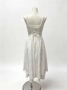 Detail view of back lace-up design on a white French style midi vacation dress.