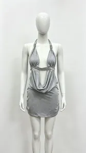 Detailed view of grey halter neck mini dress with plunging V-neck and sequin waist band