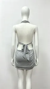Detail view of the backless tie-back design on this grey halter neck mini dress.