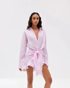 Pink long-sleeve tie-front shirt dress with ruffled hem and elegant V-neckline