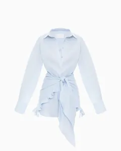 Detailed view of light blue shirt dress with elegant waist tie and ruffle hem design