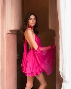 Detailed view of an elegant hot pink halter neck chiffon dress with flared sleeves