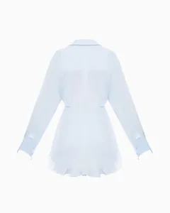Back view of fashionable light blue long-sleeved shirt dress with ruffled hem and slim fit