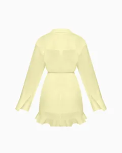 Back view of a pale yellow long-sleeved shirt dress with elegant ruffled hemline detail