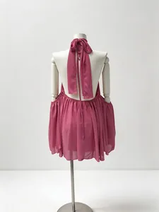 Elegant back view of rose pink halter neck chiffon mini dress on professional mannequin