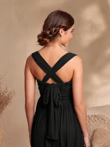 Elegant black backless pleated evening maxi dress with cross straps and bow detail