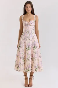 Front view of a pink floral midi dress with a corset bodice on a model in studio