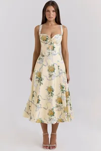 Front view of a floral spaghetti strap midi dress with yellow roses and blue ribbons
