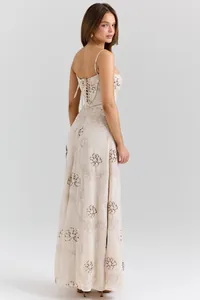 Elegant beige maxi dress with floral embroidery and corset-style lace-up back detail.