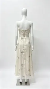 Back view of an elegant beige floral slip dress with lace-up corset back detail.