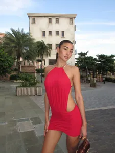 Sexy red halter neck backless mini dress for women featuring side cut-out details