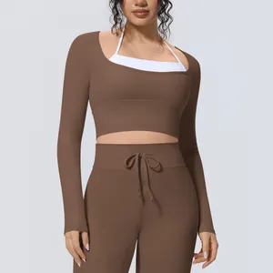 Λεπτομέρεια καφέ αθλητικού crop top με μακριά μανίκια, δύο σε ένα, για γιόγκα.