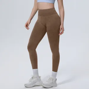 Detailed view of high-waisted brown seamless yoga leggings featuring tummy control design