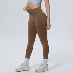 Detailed view of brown seamless high-waist washed yoga pants on a fitness model