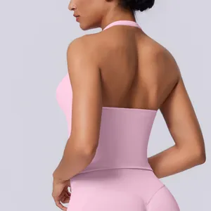 Back view of a pink seamless halter neck yoga tank top featuring a stylish open back design