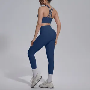 Detail view of navy blue yoga set with cross-back sports bra and high waist leggings.
