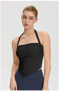Close-up front view of black halter-neck yoga top with a stylish handkerchief hem.