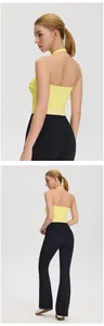 Back and full-body detail view of women's yellow halter yoga top and black flare leggings