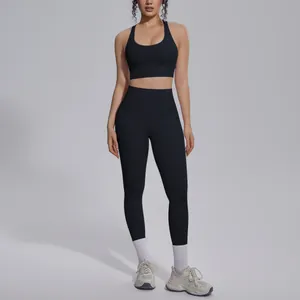 Full body view of a black seamless nylon yoga set with high-waist leggings and sports bra