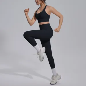Professional action shot of model in black high-waist yoga set for gym and running