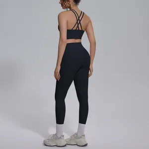 Back view of black yoga set featuring cross strap sports bra and high-waist leggings