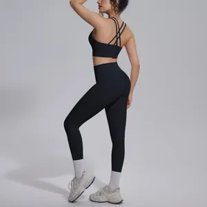 Rear view of black double-sided nylon yoga set showing cross-back design