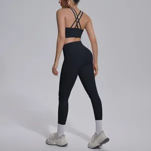 Black two-piece yoga set featuring cross-back sports bra and high-waist leggings.