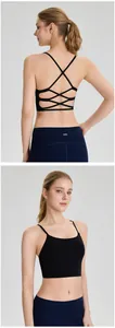 Close-up detail of black cross-back sports bra with built-in pads for yoga and fitness.