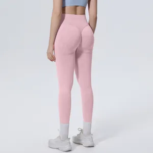 Back view of pink seamless high waist yoga leggings showing peach butt lift effect