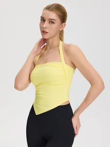 Halter neck yoga sports top in light yellow with asymmetric hem and backless design