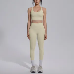 Full view of beige two-piece yoga set with cross-back sports bra and high-waist leggings