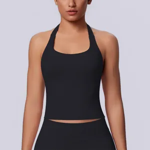 Front detail of a premium seamless black halter-neck sports top on a female model.