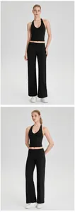 Voor- en zijaanzicht van zwarte halter yoga top en wijde sportbroek voor dames fitness