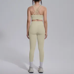 Back view of a beige cross-back sports bra and high-waist yoga leggings set