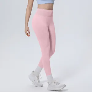 Side view detail of seamless high-waisted pink yoga leggings on a fitness model