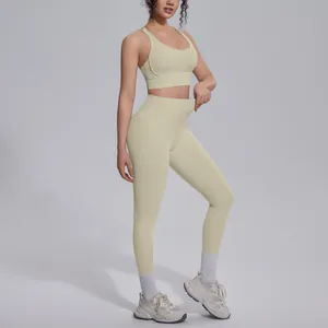 Detailed side view of cream yellow high-waisted yoga leggings and matching sports bra set.