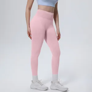 Professional model wearing pink high-waisted seamless yoga leggings with tummy control
