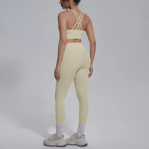 Detail view of cross-back sports bra and high-waist leggings in beige yoga set