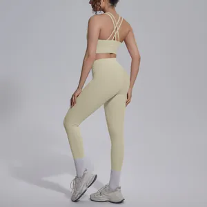 Back view of beige cross-back sports bra and high-waisted leggings set for yoga and fitness