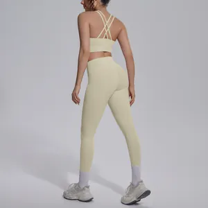 Detail view of seamless light yellow yoga set featuring criss-cross back sports bra